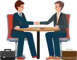 Two people sitting at a table shaking hands