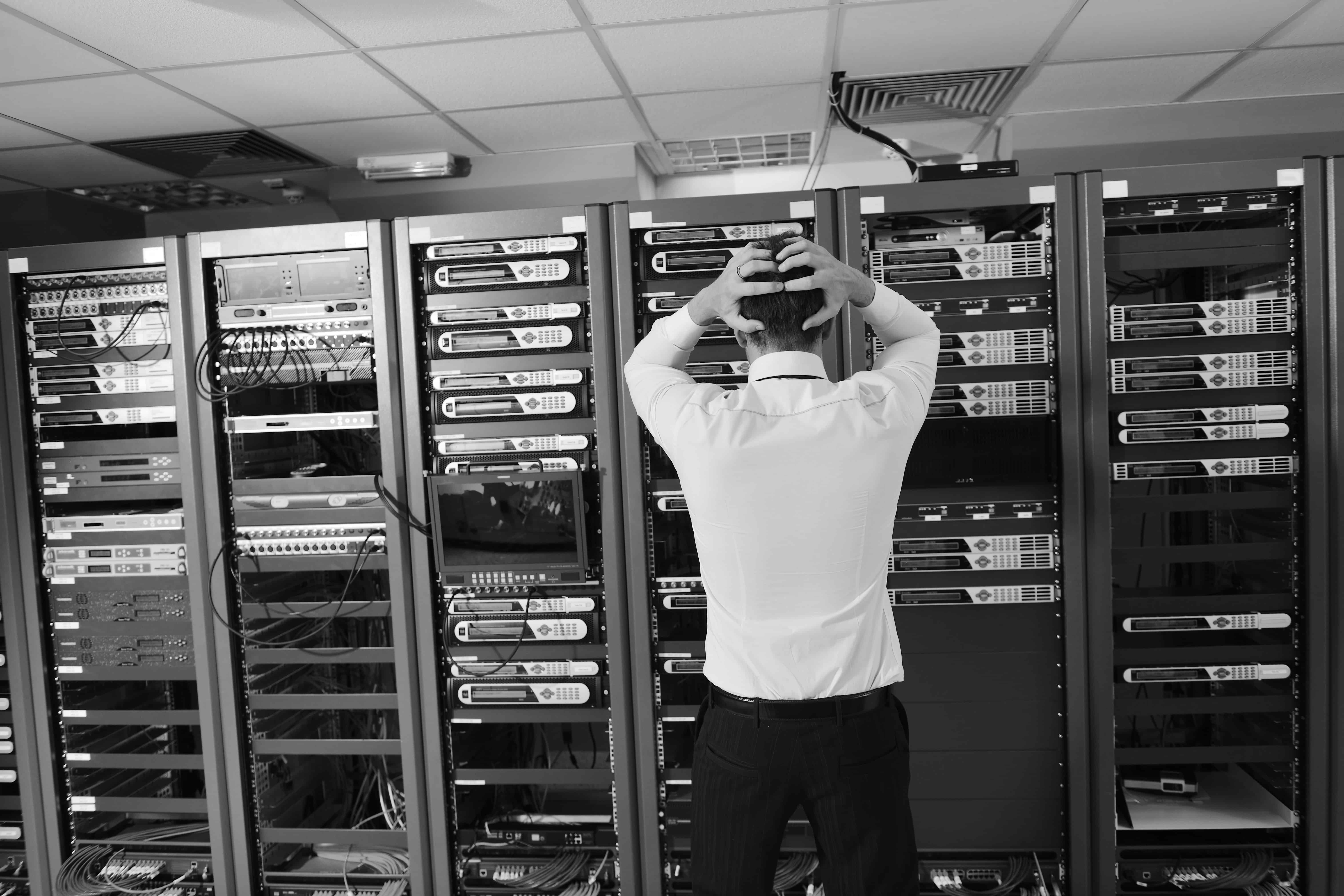 A man having problems in a server room