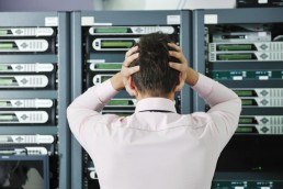 A man stressing in a server room