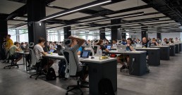 A big office of people working on laptops