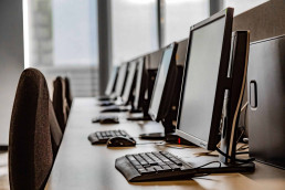 row of computers in empty office